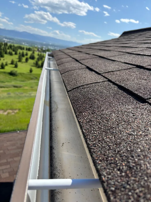 A clean gutter line on a shingle roof overlooking the Gallatin Valley